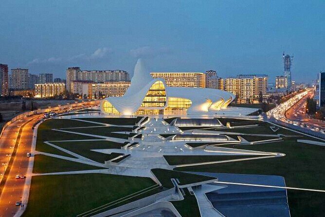 Baku Night City Tour Discover the Magic of Illuminated Landmarks - Stop 1: Flame Towers at night, color-first and camera-friendly